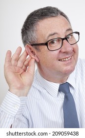 Man Holding His Ear To Hear Better