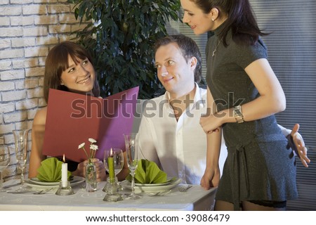 man holding his hand on waitress buttocks in a restaurant