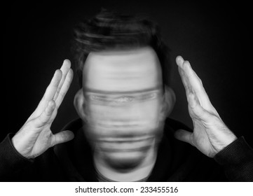 A Man Holding His Head and Shaking