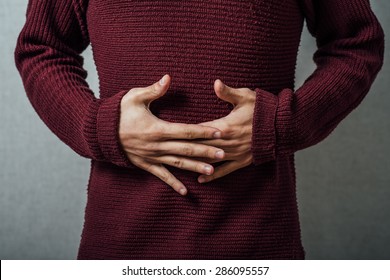 Man Holding His Stomach In Pain Or Indigestion