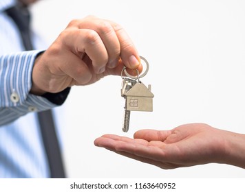 man holding a home key in his hand - Shutterstock ID 1163640952