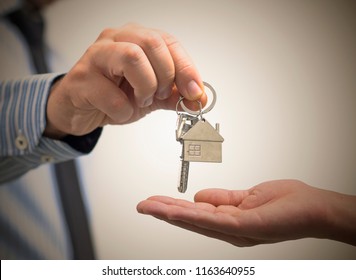 man holding a home key in his hand - Shutterstock ID 1163640955