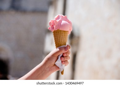 A Man Holding A Horn With Pink Ice Cream