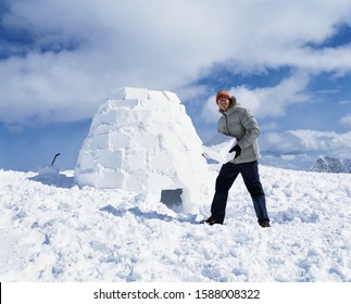 Man holding ice block and building igloo - Powered by Shutterstock