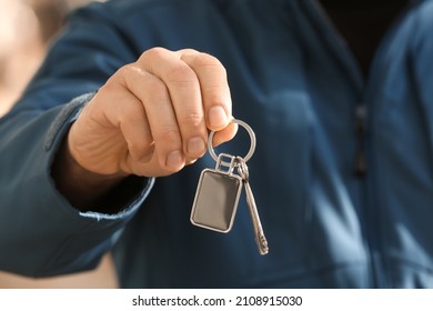 Man Holding Key On Chain, Closeup