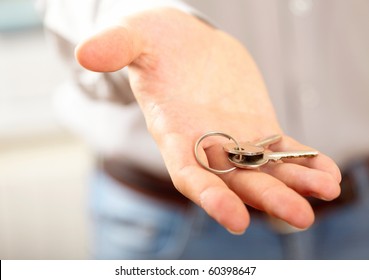 Man holding key. Shallow DOF, focus on key