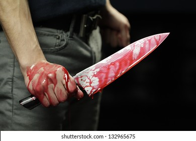 Man Holding Knife With Blood Dripping