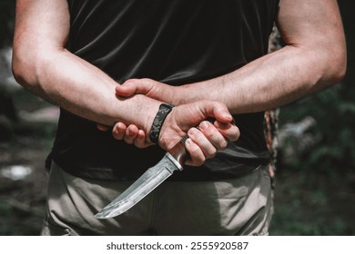 A man holding a large sharp knife in his hand.