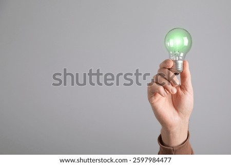 Man holding a light bulb. Creative new idea