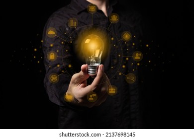 Man Holding A Light Bulb In His Hand, Idea Of Creativity And Inspiration Concept Of Sustainable Business Development. Successful Innovation Ideas And Inspiration Ideas.	