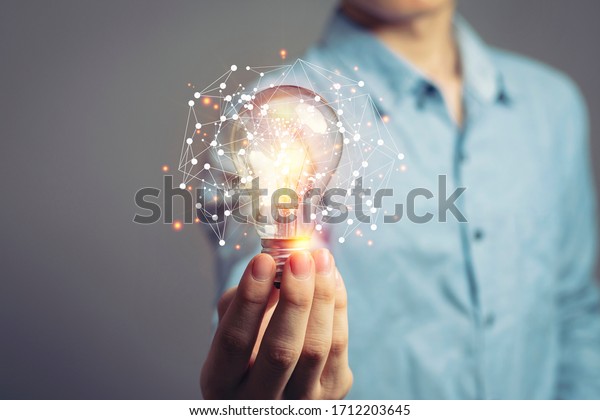 Man holding light bulbs, ideas of new ideas with\
innovative technology and creativity. concept creativity with bulbs\
that shine glitter.
