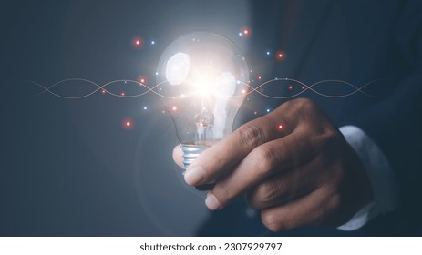 Man holding light bulbs the new ideas with innovation technology and creative. Business, Development, Concept creativity with bulbs that shine glitter. - Shutterstock ID 2307929797