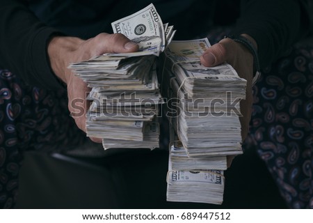 Man holding lots of money