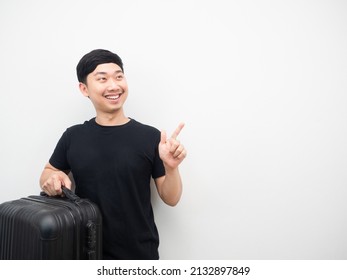 Man Holding Luggage Smiling And Point Finger At Copy Space