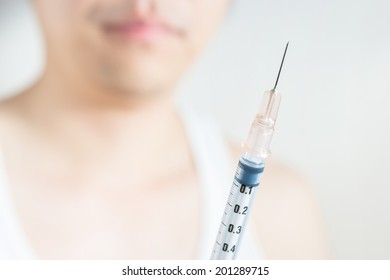 Man holding medical injection syringe