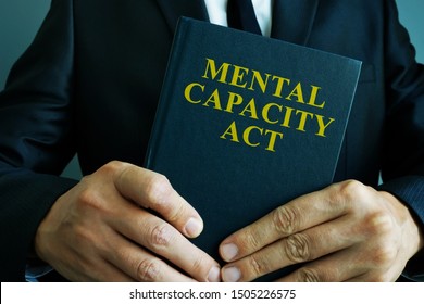 Man is holding mental capacity act. - Shutterstock ID 1505226575