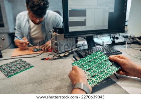A man is holding microcircuits.Concept of engineering, chip development and service.