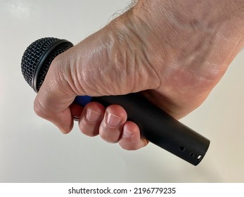 Man Holding A Microphone About To Drop The Mic