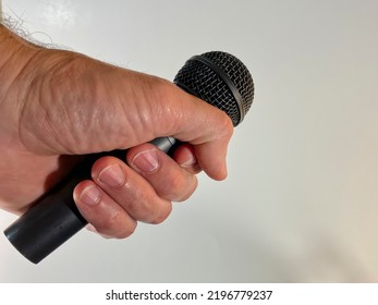 Man Holding A Microphone About To Drop The Mic