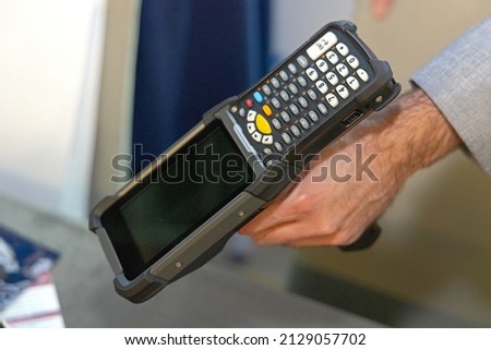 Man Holding Mobile Computer Barcode Scanner Device