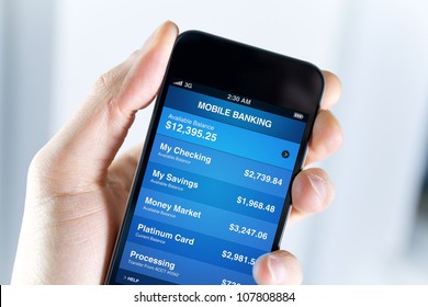 A Man Holding Mobile Smart Phone With Mobile Banking Application On A Screen. Closeup Shot.