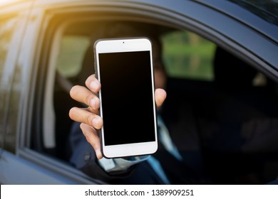 Man Holding Mobile Smart Phone In Car 