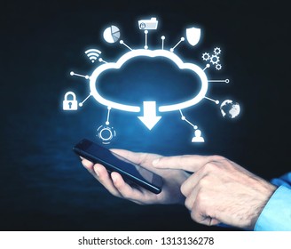 Man holding mobile smartphone. Cloud download concept - Shutterstock ID 1313136278