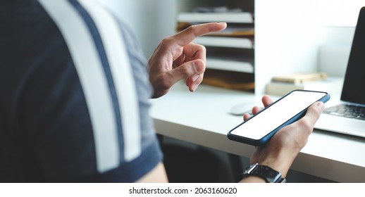 Man holding mock up smart phone. Blank screen for your text message or information content. - Shutterstock ID 2063160620