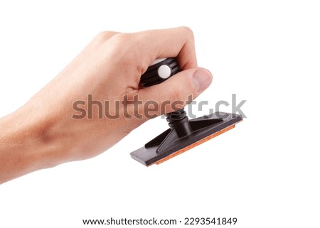 Man holding a modern professional legal office rubber stamp about to stamp sign a document, hand isolated on white, cut out. Accepting, authorizing, stamping a document, corporate decision concept