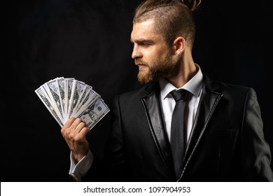 Man Holding Money In Hand At Black Background