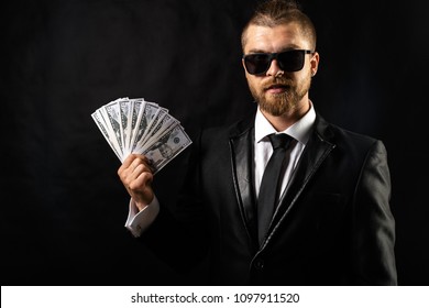 Man Holding Money In Hand At Black Background