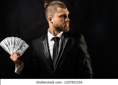 Man Holding Money In Hand At Black Background