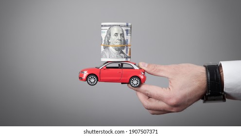 Man Holding Money And Red Toy Car.