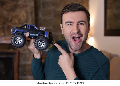 Man Holding Monster Truck Remote Controlled Toy Vehicle