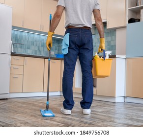 Man Holding Mop And Bucket With Cleaning Stuff