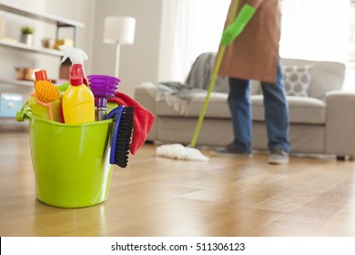 Man Holding Mop And Plastic Bucket