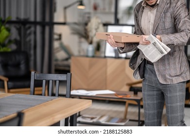 Man Holding Newspaper Box Looking At Watch