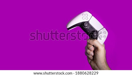 Man holding next generation controllers