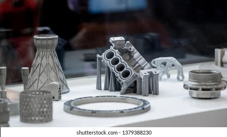 Man is holding object printed on metal 3d printer. Object printed in laser sintering machine. Modern 3D printer printing from metal powder. Progressive additive DMLS, SLM, SLS 3d printing technology
