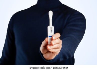 Man Holding Oral HIV Test On Blue Background. 