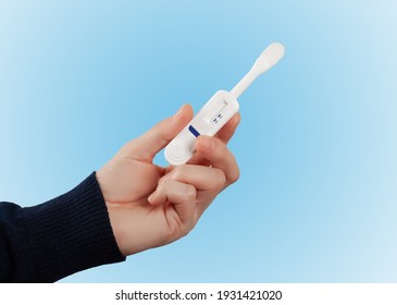 Man Holding Oral HIV Test On Blue Background. 