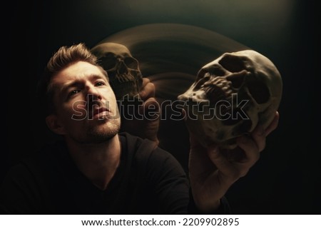 Man holding out skull offering it conceptual photo