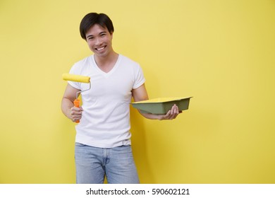 Man Holding Paint Roller And Paint Tray