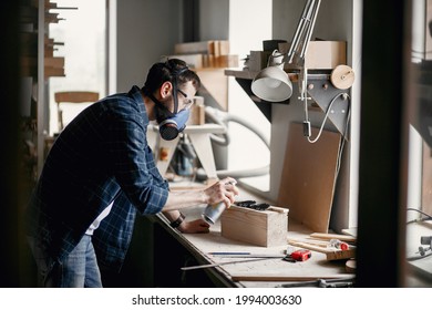 Man holding paint spray and painting wood - Powered by Shutterstock