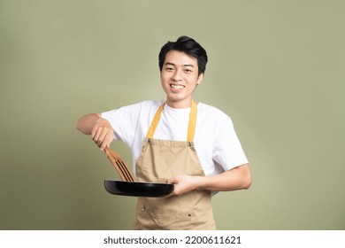 man holding a pan on the background - Powered by Shutterstock