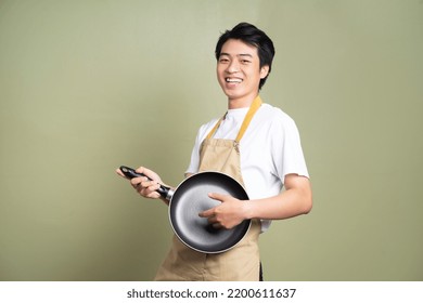 man holding a pan on the background - Powered by Shutterstock