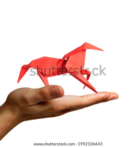 Man Holding a Paper Horse in hand. Motivation concept : Believing in your our dreams