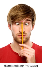 Man holding pencil between his eyes