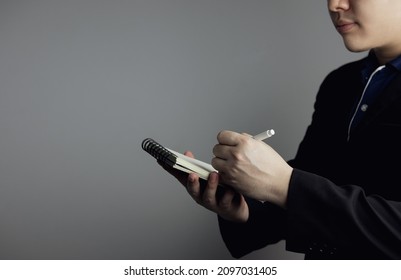man holding pencil taking short notes into notebook. concept of task planning, creativity, appointment logs, writing important things and to-do lists that will not be forgotten. important information - Powered by Shutterstock