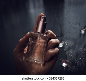 Man Holding Perfume